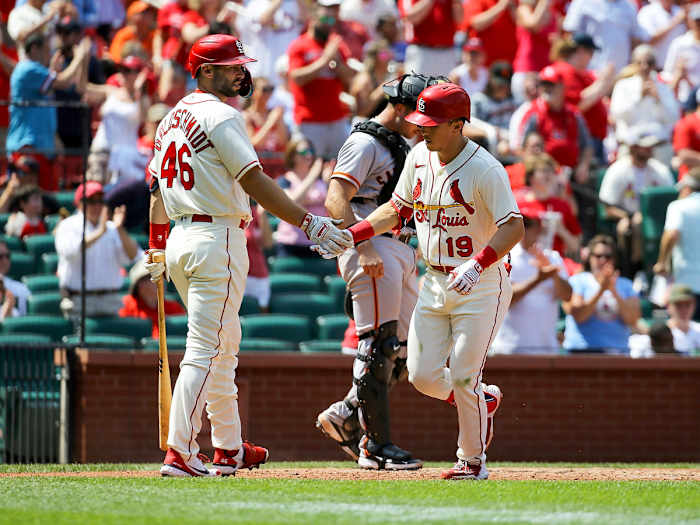 St. Louis Cardinals’ Paul Goldschmidt, left, congratulates Tommy Edman as he crosses home plate after hitting a solo home run during the fifth inning of a baseball game against the San Francisco Giants, Saturday, May 14, 2022, in St. Louis.